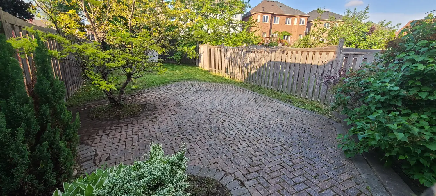 The same patio cleared, swept and edged, reading as one clean surface.