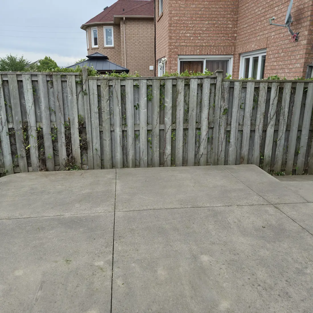 The same fence after clearing, fully exposed with a clean pad below.